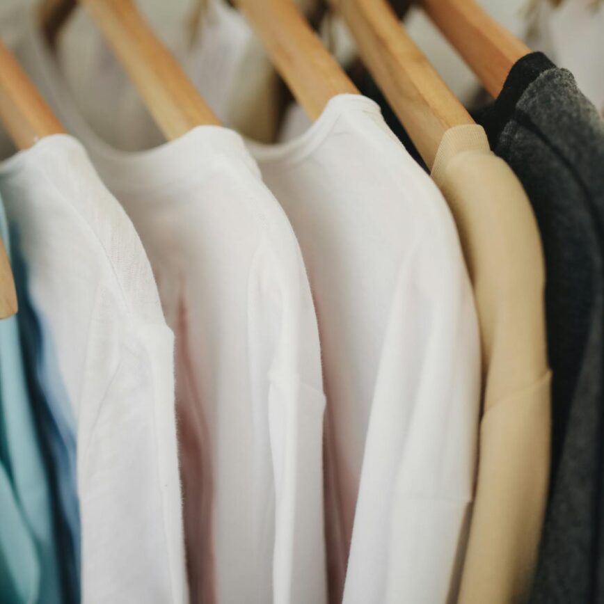 white long sleeves shirts on brown wooden clothes hanger