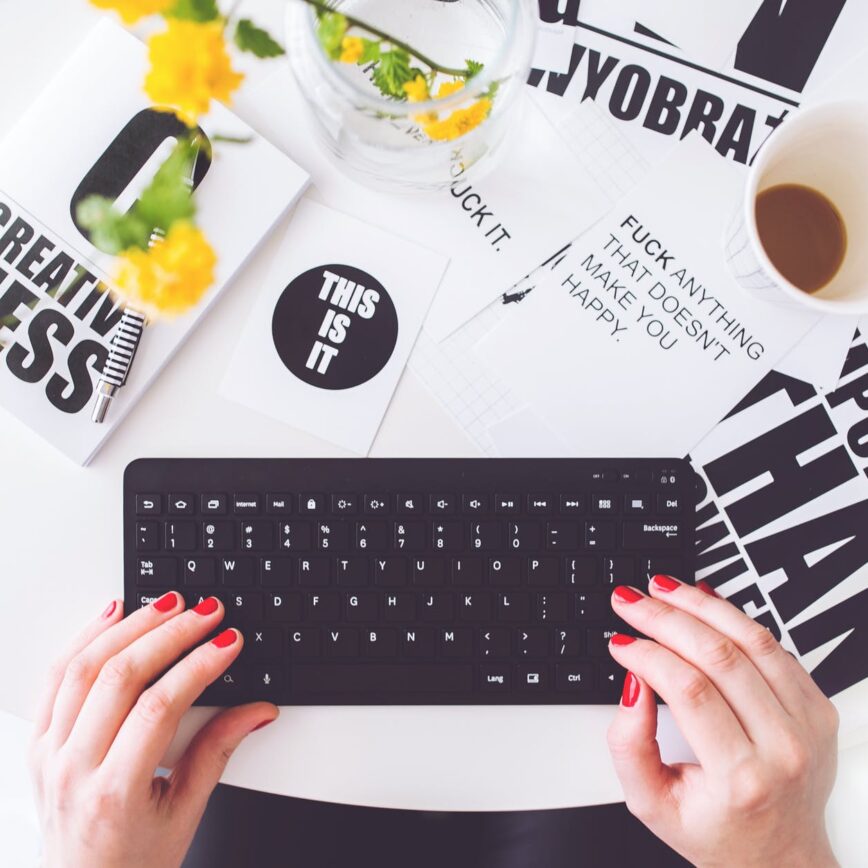 girl writing on a black keyboard