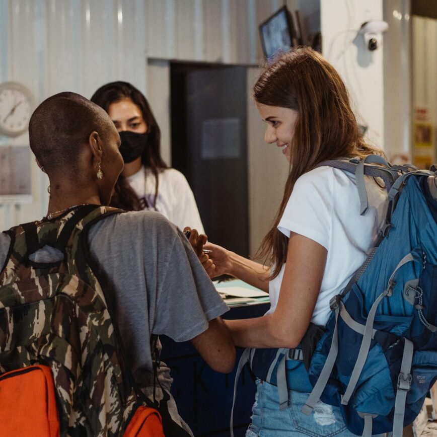 women checking in and picking up keys for the hotel room