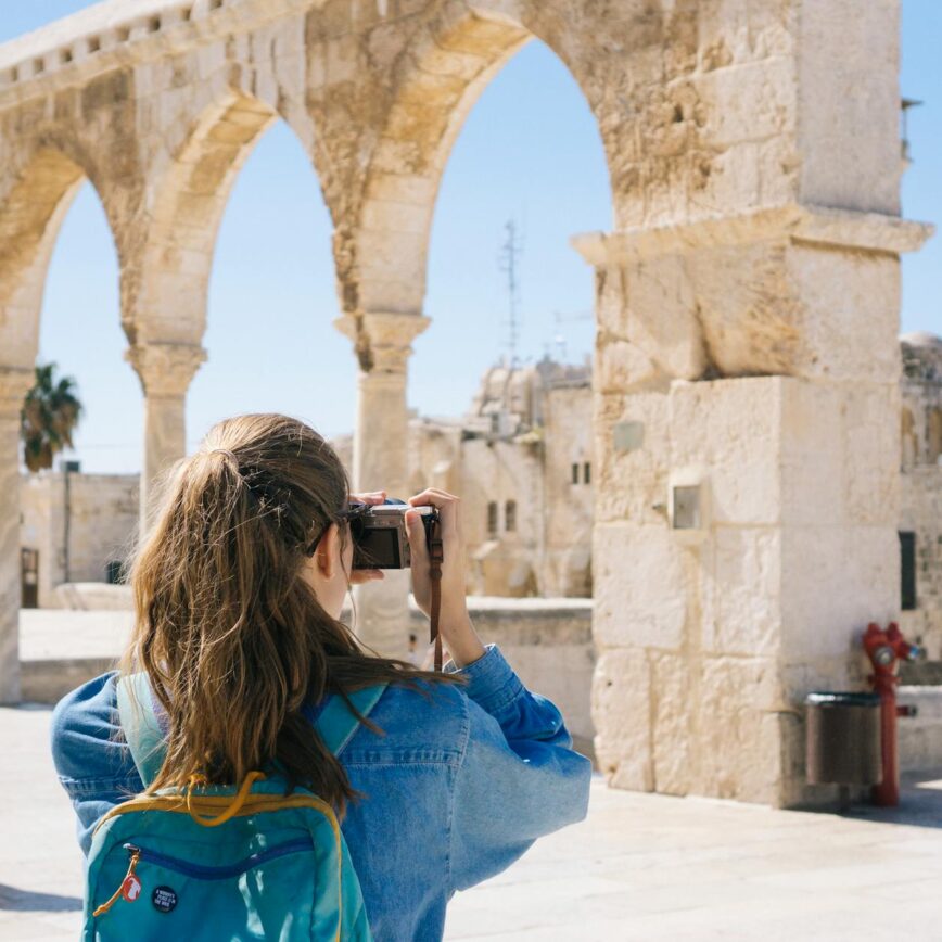 woman taking pictures of ruins